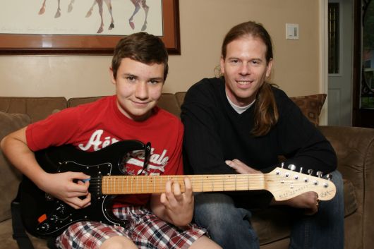 Student practicing electric guitar with a teacher during an in-studio guitar lesson in Toronto